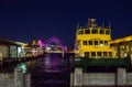 Circular quay wharf with the view of Sydney harbour bridge at night time. Royalty Free Stock Photo